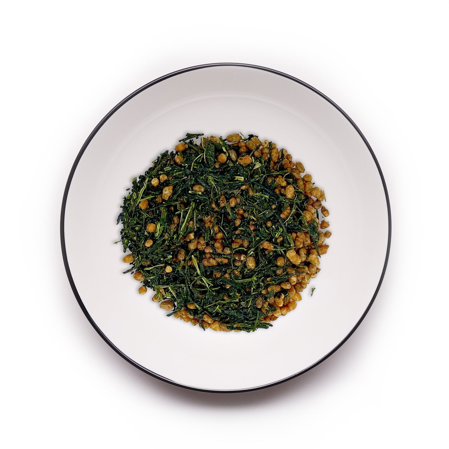 Premium Uji Genmaicha tea from MAISON TOMOKI on a white plate with a black rim, showcasing vibrant green tea leaves mixed with roasted rice for a nutty, aromatic blend.