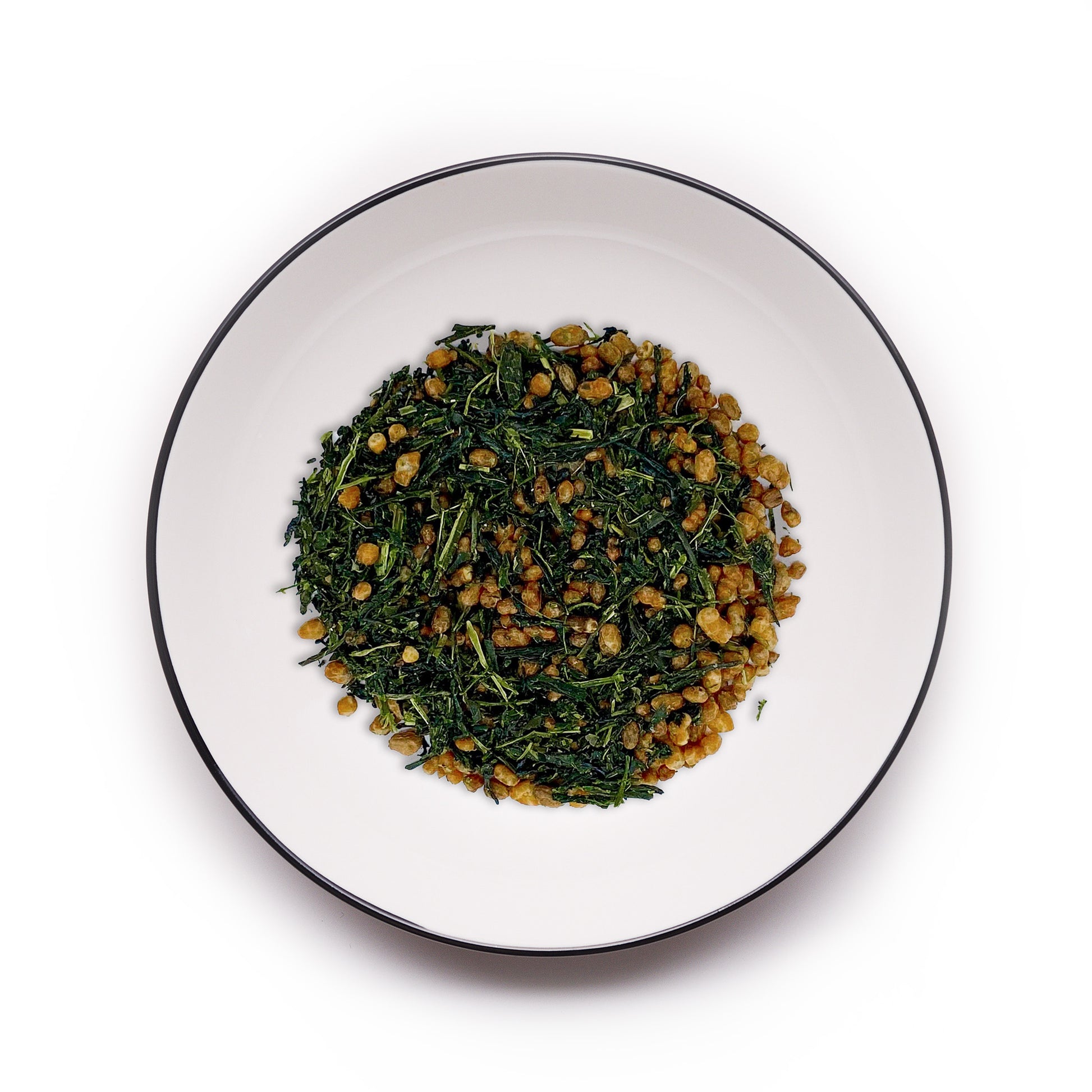 Premium Uji Genmaicha tea from MAISON TOMOKI on a white plate with a black rim, showcasing vibrant green tea leaves mixed with roasted rice for a nutty, aromatic blend.